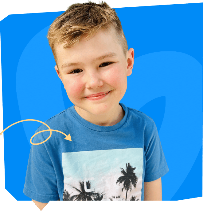 A smiling young boy wearing a blue t-shirt with a palm tree design, set against a bright blue background.
