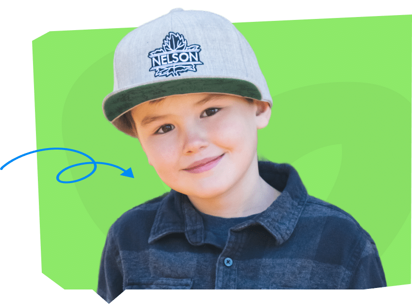 A smiling child wearing a gray cap with "NELSON" on it and a dark plaid shirt, set against a bright green background.